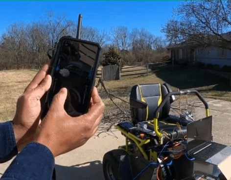Operating Mobimower with a smartphone remote — custom yellow robotic platform in the field